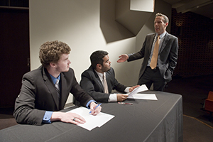 Todd Graham, SIU Debate Team Coach, advises Josh Rivera and Zach Schneider