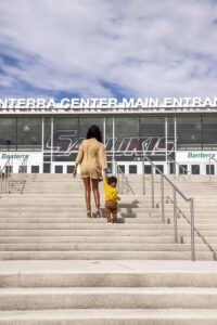 Kierra Greer holds hands with her son and walks up the steps of the SIU Banterra Center.