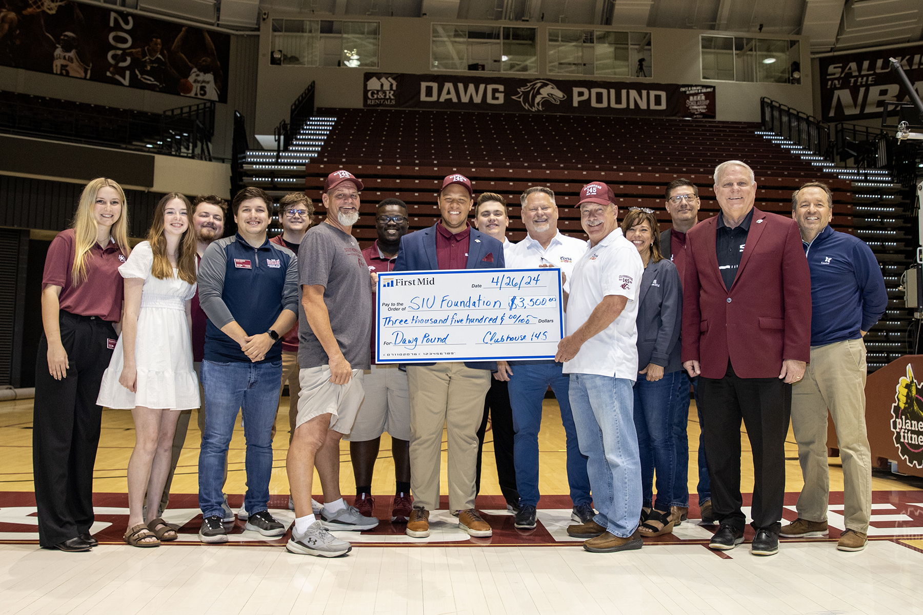 Clubhouse 145 presents check for $3,500 to the Dawg Pound.