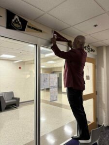 Chancellor Austin Lane places the Saluki flag at Ben Davis High School as part of SIU’s inaugural Indianapolis Takeover Tour.