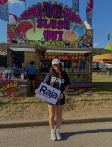 Anna Stearns holds sign for Raja Krishnamoorthi's Senate campaign.