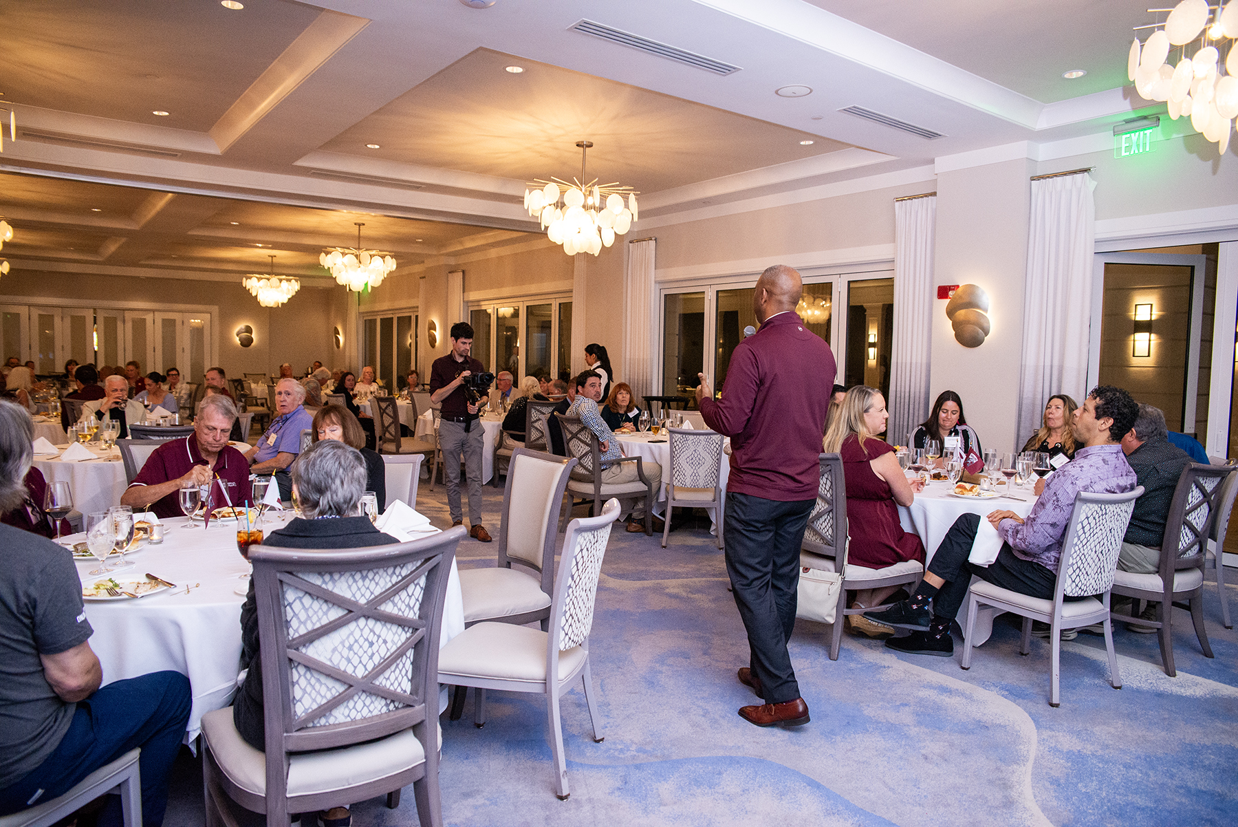 SIU Chancellor Austin A. Lane addresses alumni and friends during the Chancellor’s Reception in Naples as attendees sit at round tables inside Windstar on Naples Bay, listening and dining during the 4th Annual Saluki Takeover Tour Florida.