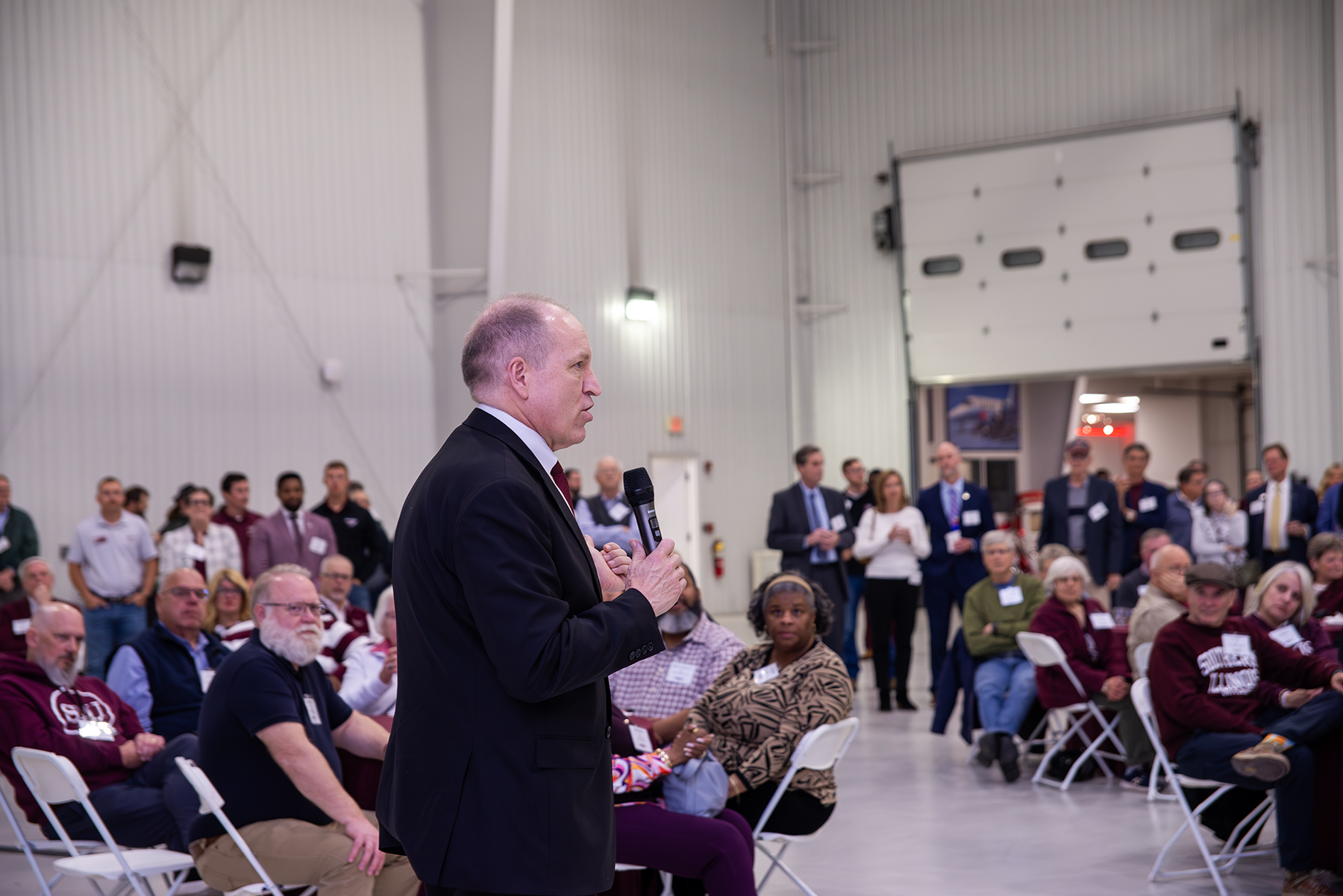 SIU System President Daniel Mahony speaks to attendees gathered inside the LRS Hangar during the Saluki Takeover Tour Springfield Chancellor’s Reception.
