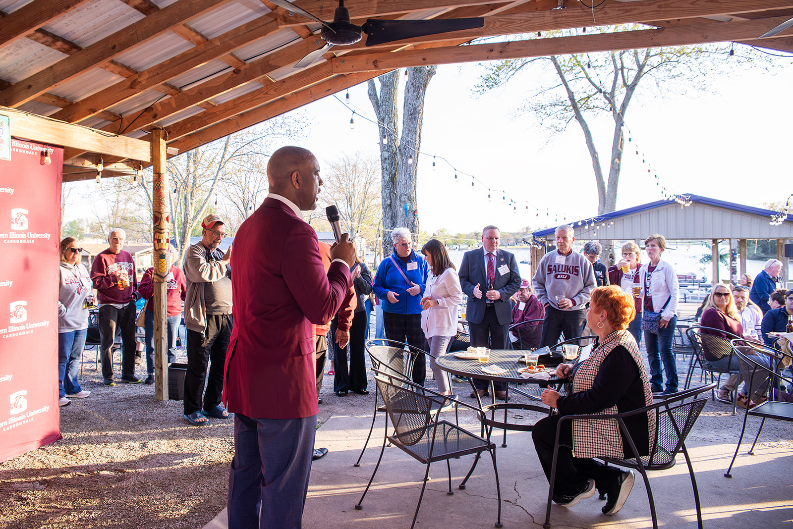 Chancellor Austin A. Lane addresses attendees along the Lake of Egypt waterfront during the Saluki Takeover Tour Southern Illinois event at Pyramid Acres Marina in Marion on April 7.