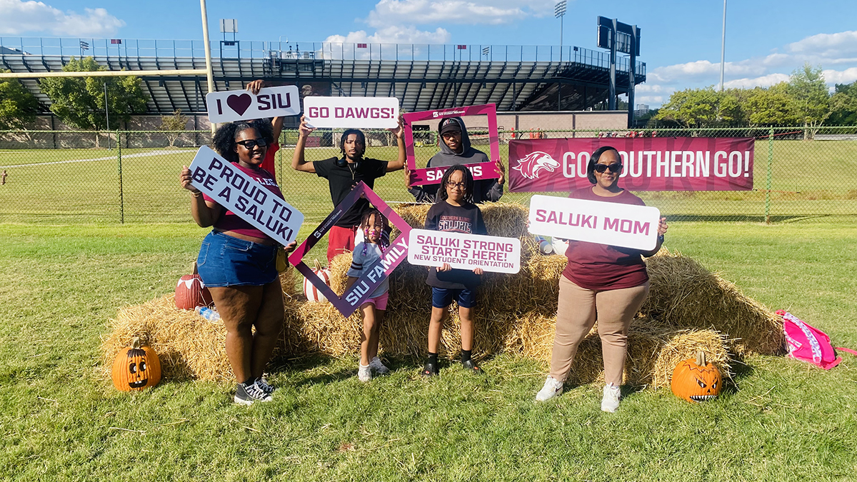 T'Andrea and her family are pictured holding Saluki-theme songs for Family Weekend Family of the Year.