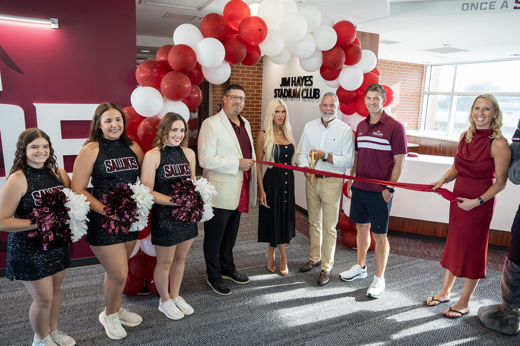 Jamie and Netta Hayes cut the ribbon during the dedication of the Jim Hayes Stadium Club at Saluki Stadium on Thursday, Aug. 13. The newly renovated space, named in honor of Jamie Hayes' father and longtime Saluki supporter Jim Hayes, was made possible through the couple's $1 million gift to Saluki Athletics.