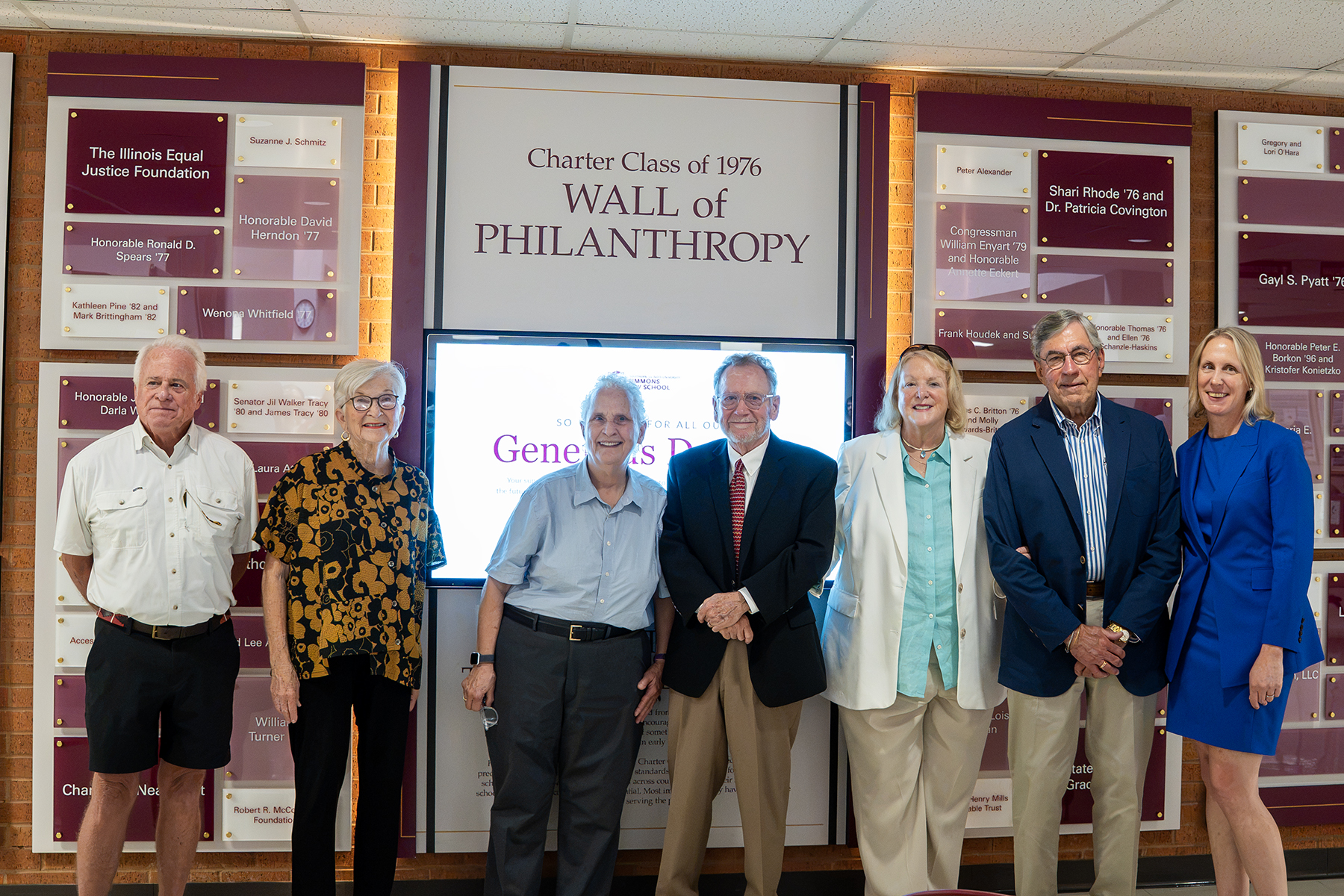 Donors and members of the SIU Simmons Law School charter class stand in front of the newly unveiled Wall of Philanthropy.
