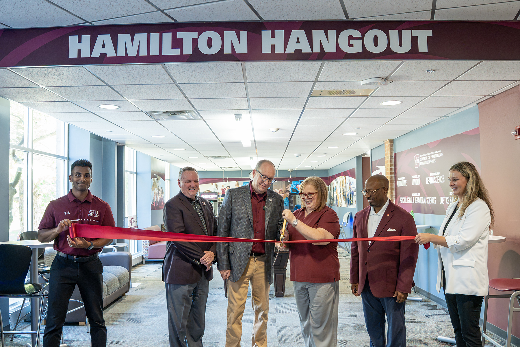 Chuck and Tracy Hamilton cut the ribbon in front of the newly dedicated Hamilton Hangout in SIU's Mae Smith Hall.