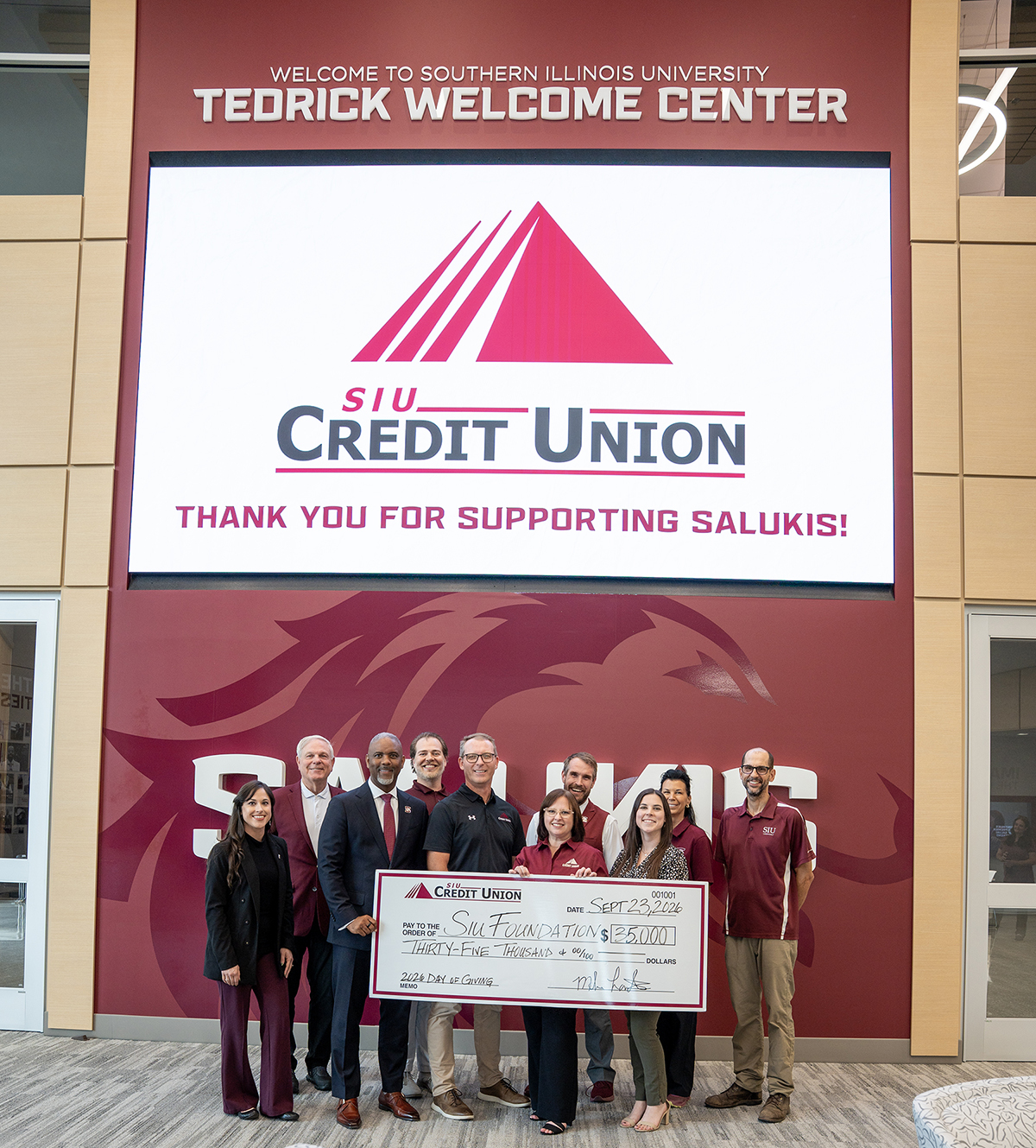 SIU Credit Union representatives present a check for $35,000 with SIU leadership.