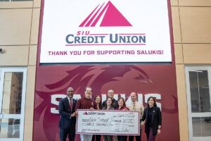 SIU Credit Union representatives present a check for $20,000 with SIU New Student Programs.